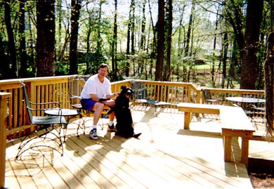 My dad and my dog on the deck in my backyard.