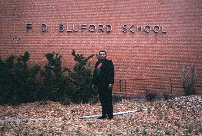 This is a picture of my mom standing in front of her old school, F.D. Bluford School.