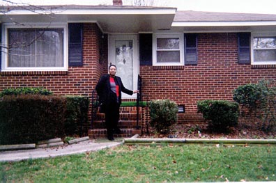 My third picture is my mom in front of my Grandmother's house.