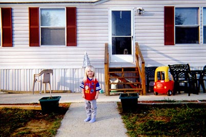My sister Danielle standing in front of our house.
